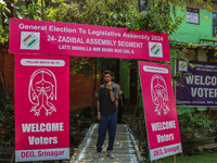 A man shows his ink-marked finger after casting his ballot at a polling station during the second phase of assembly elections in Srinagar, J...