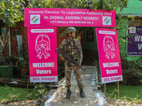 An Indian paramilitary soldier stands guard outside a polling station during the second phase of assembly elections in Srinagar, Jammu and K...