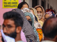 Voters queue to cast their ballots at a polling station during the second phase of assembly elections in Srinagar, Jammu and Kashmir, on Sep...