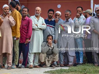 Voters queue to cast their ballots at a polling station during the second phase of assembly elections in Srinagar, Jammu and Kashmir, on Sep...