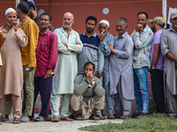 Voters queue to cast their ballots at a polling station during the second phase of assembly elections in Srinagar, Jammu and Kashmir, on Sep...