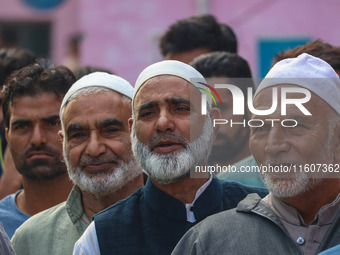 Voters queue to cast their ballots at a polling station during the second phase of assembly elections in Srinagar, Jammu and Kashmir, on Sep...