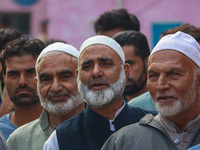 Voters queue to cast their ballots at a polling station during the second phase of assembly elections in Srinagar, Jammu and Kashmir, on Sep...