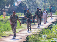 Indian security personnel walk in the interiors of Dal Lake during the second phase of assembly elections in Srinagar, Jammu and Kashmir, on...