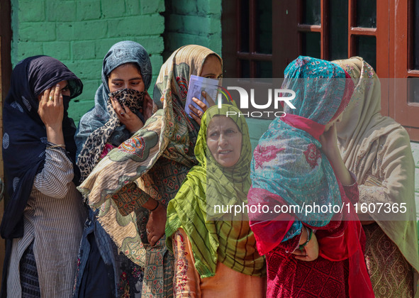 Women voters queue to cast their ballots at a polling station during the second phase of assembly elections in Srinagar, Jammu and Kashmir,...