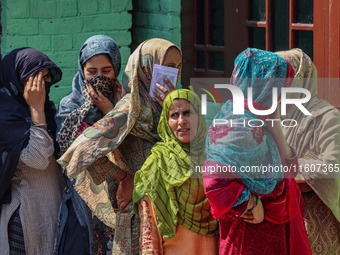 Women voters queue to cast their ballots at a polling station during the second phase of assembly elections in Srinagar, Jammu and Kashmir,...