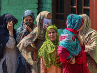 Women voters queue to cast their ballots at a polling station during the second phase of assembly elections in Srinagar, Jammu and Kashmir,...