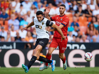 Cesar Tarrega of Valencia CF competes for the ball with Raul of CA Osasuna during the LaLiga EA Sports match between Valencia CF and CA Osas...