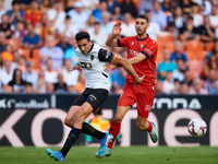 Cesar Tarrega of Valencia CF competes for the ball with Raul of CA Osasuna during the LaLiga EA Sports match between Valencia CF and CA Osas...