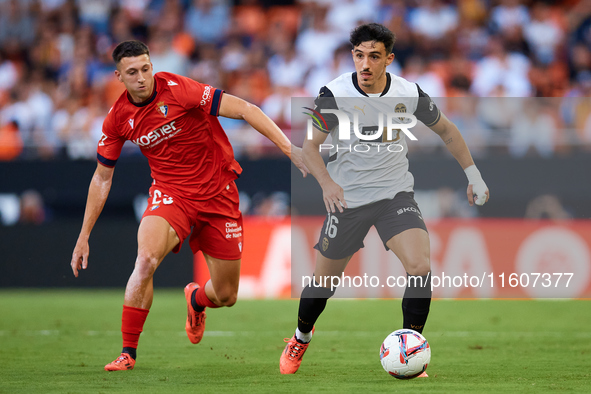 Diego Lopez of Valencia CF competes for the ball with Abel Bretones of CA Osasuna during the LaLiga EA Sports match between Valencia CF and...