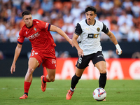 Diego Lopez of Valencia CF competes for the ball with Abel Bretones of CA Osasuna during the LaLiga EA Sports match between Valencia CF and...