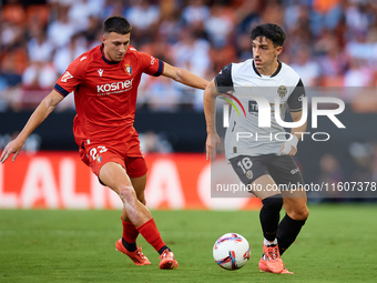 Diego Lopez of Valencia CF competes for the ball with Abel Bretones of CA Osasuna during the LaLiga EA Sports match between Valencia CF and...