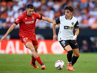 Diego Lopez of Valencia CF competes for the ball with Abel Bretones of CA Osasuna during the LaLiga EA Sports match between Valencia CF and...