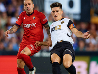 Pepelu of Valencia CF competes for the ball with Ruben Pena of CA Osasuna during the LaLiga EA Sports match between Valencia CF and CA Osasu...