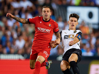 Pepelu of Valencia CF competes for the ball with Ruben Pena of CA Osasuna during the LaLiga EA Sports match between Valencia CF and CA Osasu...