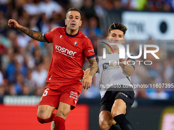 Pepelu of Valencia CF competes for the ball with Ruben Pena of CA Osasuna during the LaLiga EA Sports match between Valencia CF and CA Osasu...