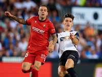 Pepelu of Valencia CF competes for the ball with Ruben Pena of CA Osasuna during the LaLiga EA Sports match between Valencia CF and CA Osasu...