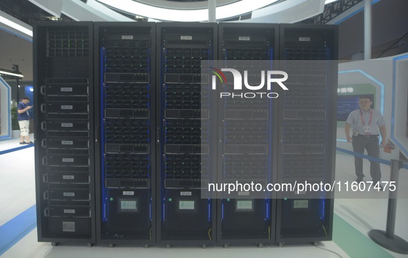 Visitors look at the supercomputer of Zhejiang Lab's new Computing Power Center at the Global Digital Trade Expo in Hangzhou, China, on Sept...