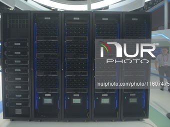 Visitors look at the supercomputer of Zhejiang Lab's new Computing Power Center at the Global Digital Trade Expo in Hangzhou, China, on Sept...