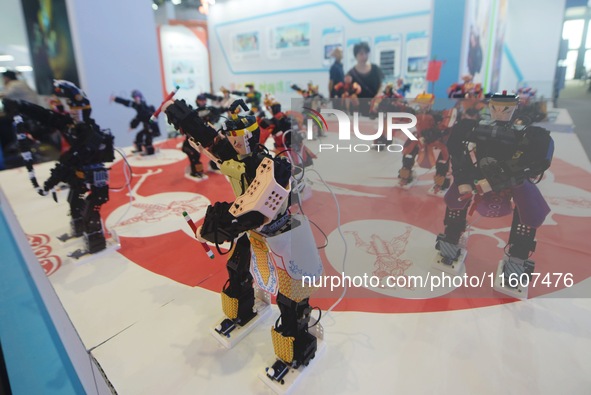 Visitors watch a robot perform a song and dance performance at the Global Digital Trade Expo in Hangzhou, Zhejiang province, China, on Septe...