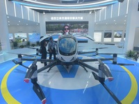 Viewers watch Yihang's "flying car" electric vertical takeoff and landing aircraft (eVTOL) at the Global Digital Trade Expo in Hangzhou, Chi...