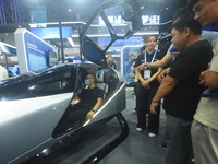 Viewers experience Xiaopeng Motors' "flying car" electric vertical takeoff and landing aircraft (eVTOL) at the Global Digital Trade Expo in...