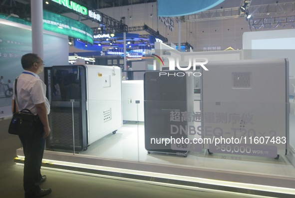 Viewers watch BGI Genomics' ultra-high throughput sequencer at the Global Digital Trade Expo in Hangzhou, China, on September 25, 2024. 