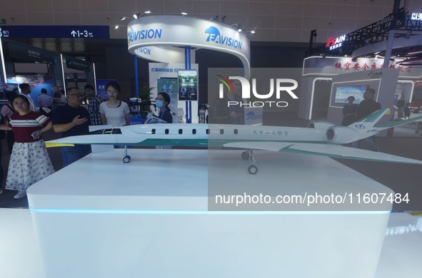 Viewers watch a domestically produced supersonic business jet design model at the Global Digital Trade Expo in Hangzhou, China, on September...