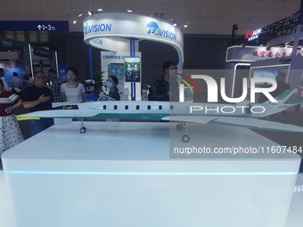 Viewers watch a domestically produced supersonic business jet design model at the Global Digital Trade Expo in Hangzhou, China, on September...