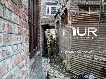 An Indian paramilitary trooper stands alert at a polling station during the second phase of assembly elections in Srinagar, Indian Administe...