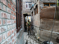 An Indian paramilitary trooper stands alert at a polling station during the second phase of assembly elections in Srinagar, Indian Administe...