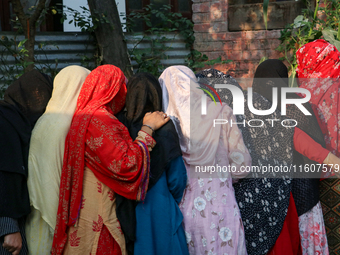 People stand in line to cast their vote at a polling station during the second phase of assembly elections in Srinagar, Indian Administered...