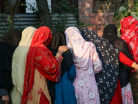 People stand in line to cast their vote at a polling station during the second phase of assembly elections in Srinagar, Indian Administered...