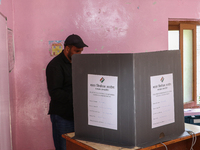 A man casts his vote at a polling station during the second phase of assembly elections in Srinagar, Indian Administered Kashmir, on Septemb...