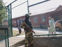 An Indian paramilitary trooper stands alert at a polling station during the second phase of assembly elections in Srinagar, India, on Septem...