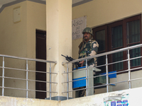 An Indian paramilitary trooper stands alert at a polling station during the second phase of assembly elections in Srinagar, India, on Septem...