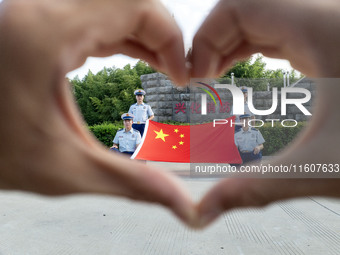 Firefighters pose for a photo with the national flag at the Fire and Rescue Brigade in Xinghua, China, on September 25, 2024. (