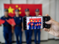 Firefighters pose for a photo with the national flag at the Fire and Rescue Brigade in Xinghua, China, on September 25, 2024. (