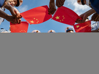 Firefighters pose for a photo with the national flag at the Fire and Rescue Brigade in Xinghua, China, on September 25, 2024. (