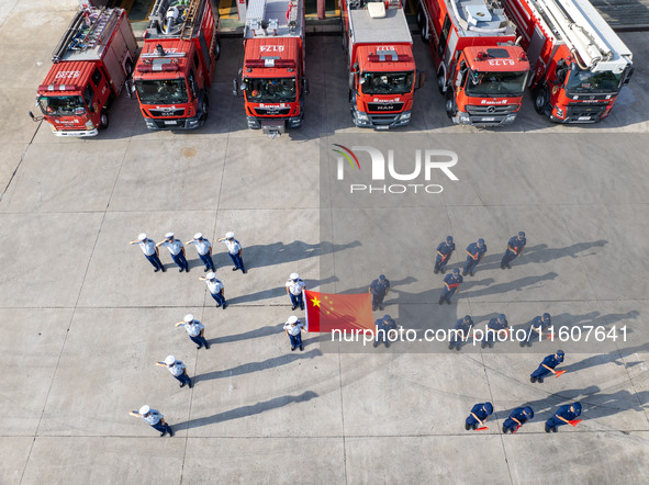 Firefighters stand for the 75th anniversary at the Fire and Rescue brigade in Xinghua, China, on September 25, 2024. 