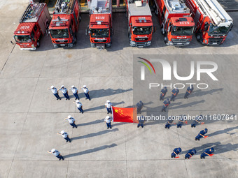 Firefighters stand for the 75th anniversary at the Fire and Rescue brigade in Xinghua, China, on September 25, 2024. (