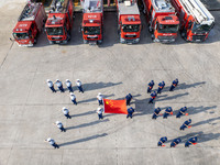 Firefighters stand for the 75th anniversary at the Fire and Rescue brigade in Xinghua, China, on September 25, 2024. (