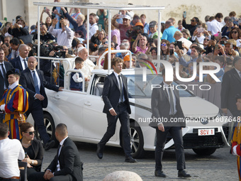 Pope Francis waves to the faithful during the weekly general audience in Saint Peter's Square. (