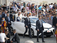 Pope Francis waves to the faithful during the weekly general audience in Saint Peter's Square. (