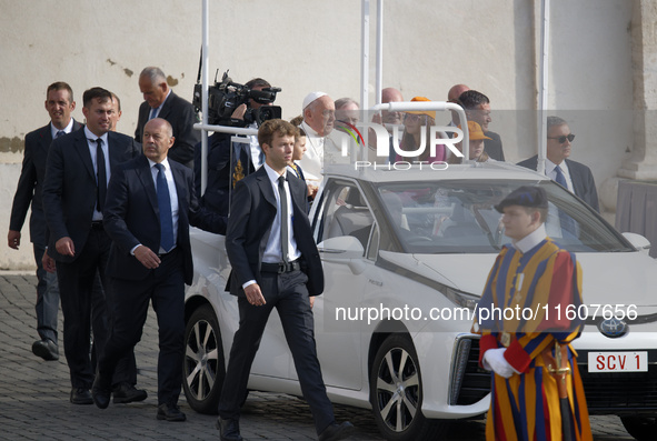 Pope Francis sits on a Toyota Mirai hydrogen-powered popemobile at the end of the weekly general audience in The Vatican, on September 25, 2...