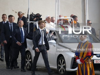 Pope Francis sits on a Toyota Mirai hydrogen-powered popemobile at the end of the weekly general audience in The Vatican, on September 25, 2...