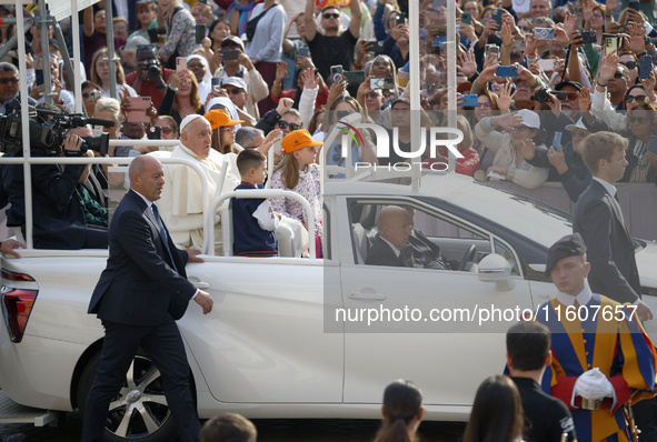 Pope Francis sits on a Toyota Mirai hydrogen-powered popemobile at the end of the weekly general audience in The Vatican, on September 25, 2...