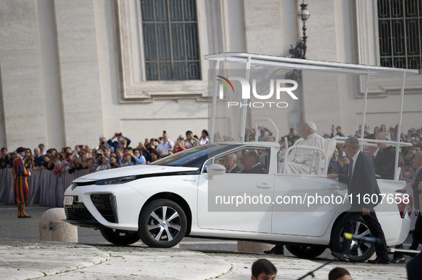 Pope Francis sits on a Toyota Mirai hydrogen-powered popemobile at the end of the weekly general audience in The Vatican, on September 25, 2...