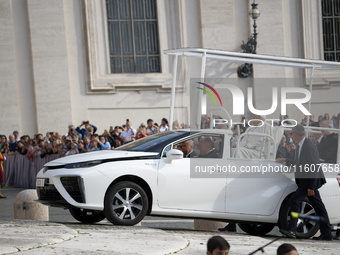 Pope Francis sits on a Toyota Mirai hydrogen-powered popemobile at the end of the weekly general audience in The Vatican, on September 25, 2...