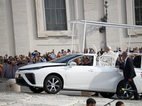 Pope Francis sits on a Toyota Mirai hydrogen-powered popemobile at the end of the weekly general audience in The Vatican, on September 25, 2...